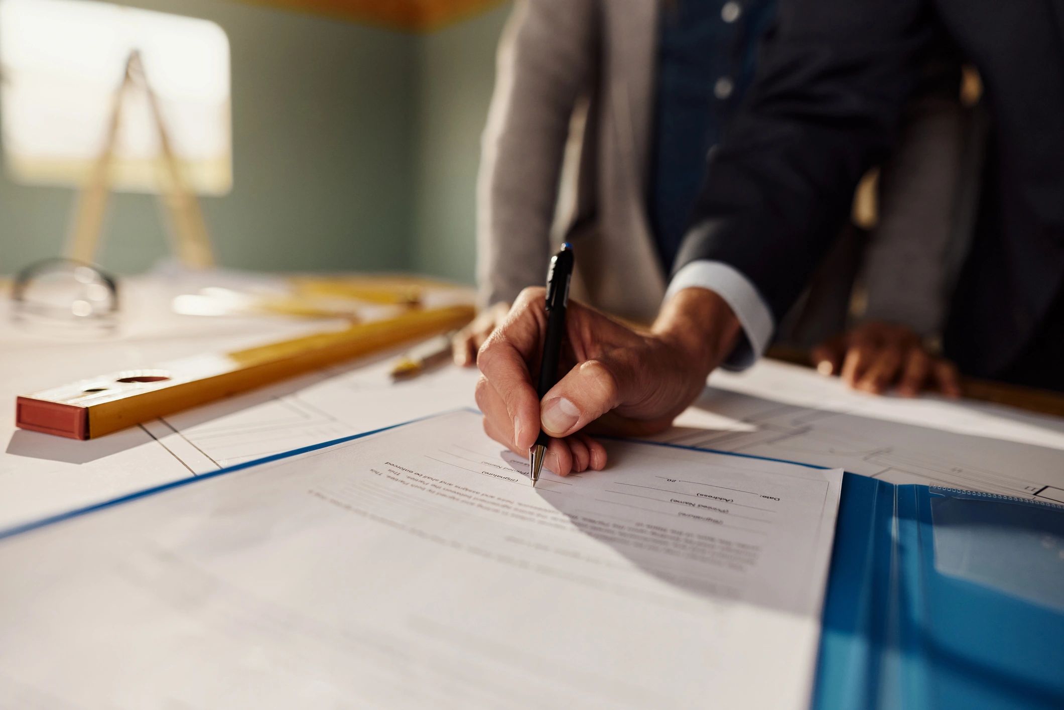 Close-up of a professional signing a contract document
